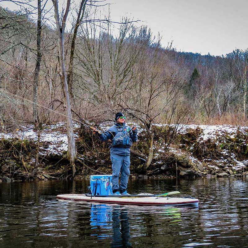 "Pau Hana Surf Supply 11'0" Navio VFT paddler false casting a  fly rod in early spring on Vermont reservoir"