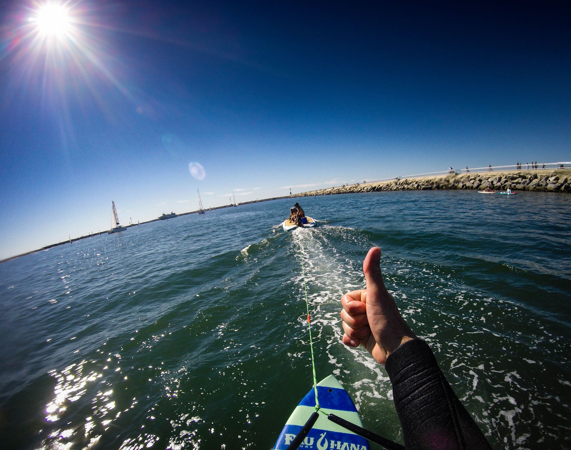 a SUP foil being towed by the bimini skiff paddleboard in a harbor