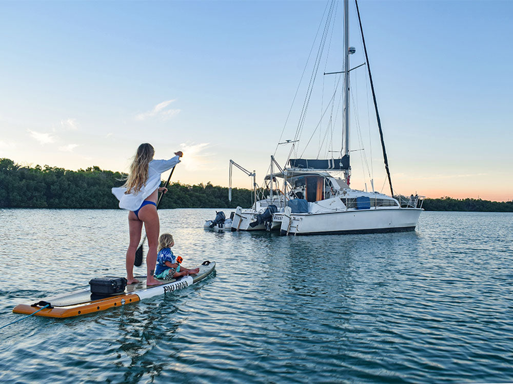 A woman paddling past a boat in key west in florida