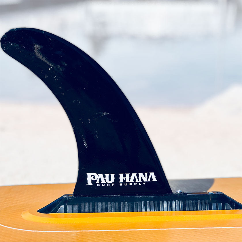 Pau Hana Surf Supply branded SUP fin in 10-inch snap-lock finbox system, close-up detail showing rail attachment on orange board surface