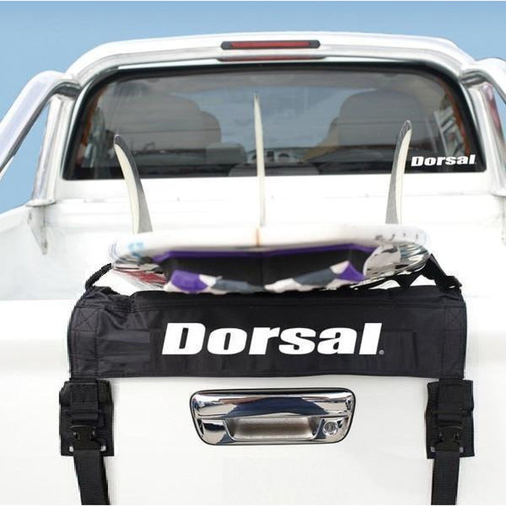 Dorsal roof rack system on a white truck with surfboards attached