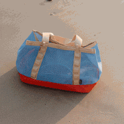 A gif of a tote bag with waves lapping around