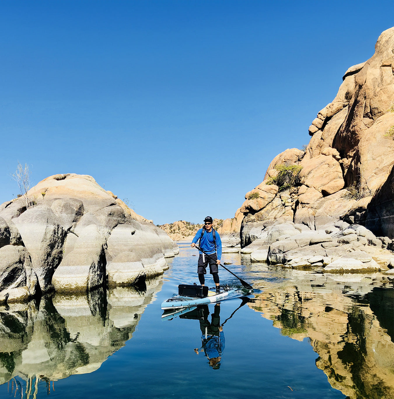 "Pau Hana Surf Supply 12'0" Endurance XL touring stand-up paddleboard in pristine desert canyon waters, granite rock formations frame paddler exploring remote reservoir"