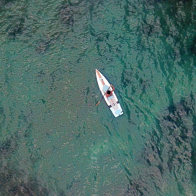 "Aerial image of Pau Hana Surf Supply lightweight 10'10" Mini Sport fitness SUP in Hawaii"