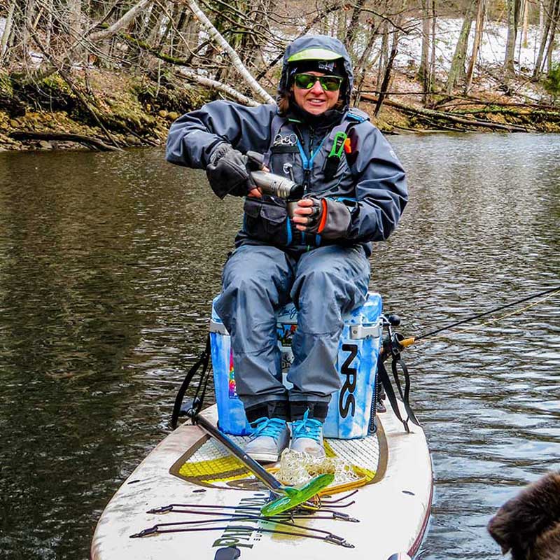 &quot;Pau Hana Surf Supply Navio VFT paddler enjoying hot tea on cooler, dressed warm with attached fly rod&quot;