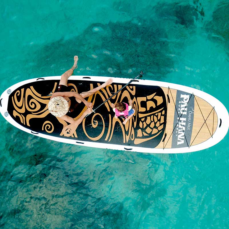 Aerial image of father and child on the Pau Hana Surf Supply Oahu Nui giant inflatable family paddleboard in Oahu