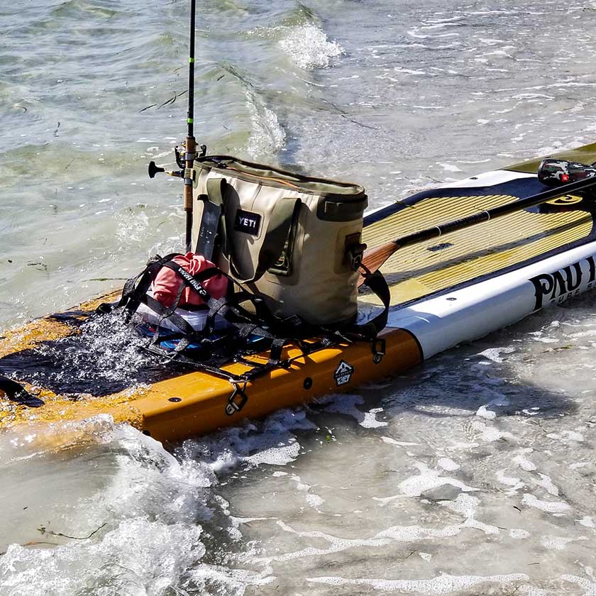 Pau Hana Surf Supply Endurance with Seamount rigging system equipped for fishing, featuring mounted cooler and rod holder in choppy surf conditions