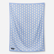 Blue towel with white geometric pattern on a white background