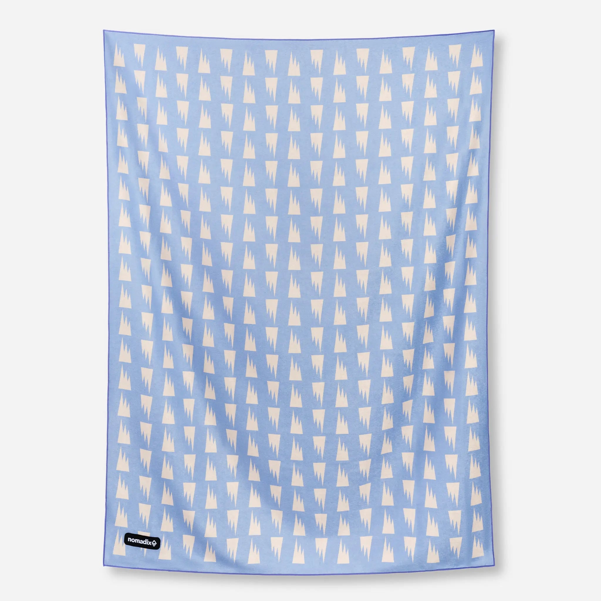 Blue towel with white geometric pattern on a white background
