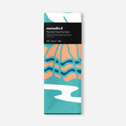 Folded towel with colorful design and Nomadix branding on a white background