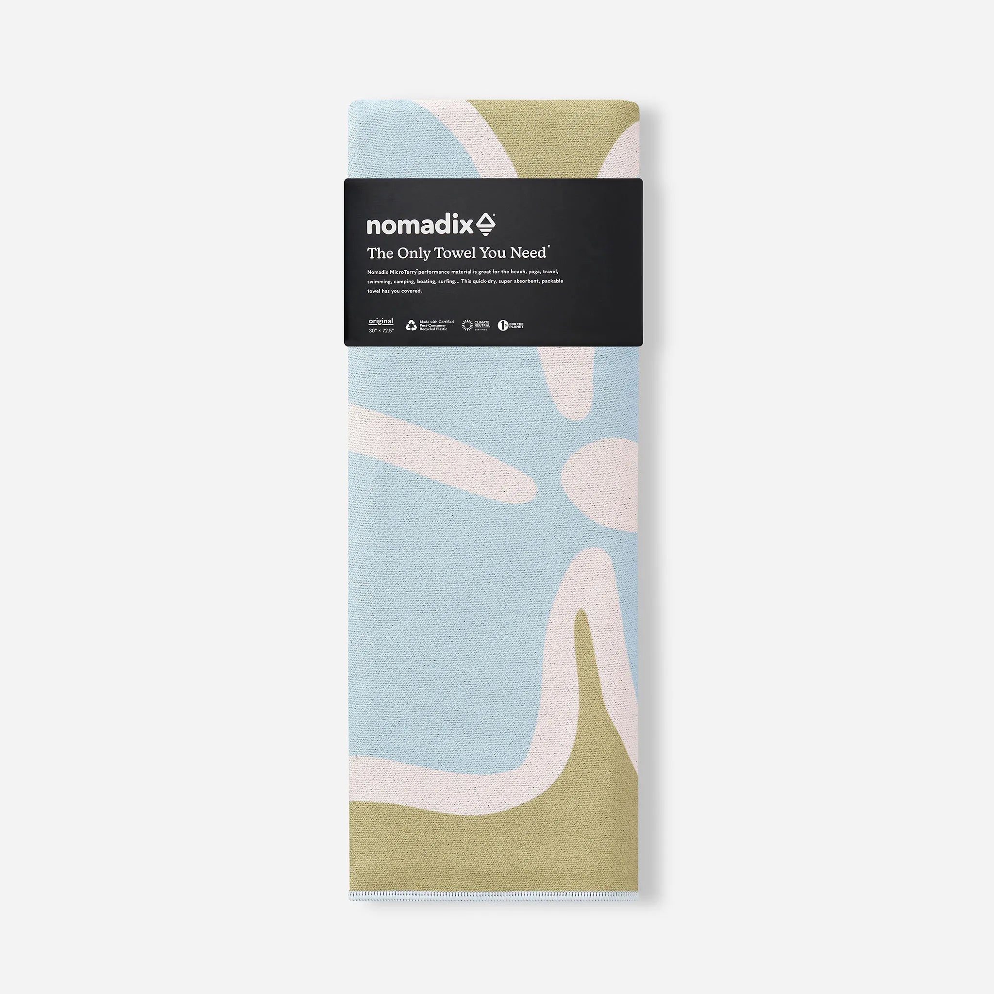 A folded Nomadix towel with an abstract organic pattern in light blue, sage green, and pale pink, wrapped in a black paper header band.