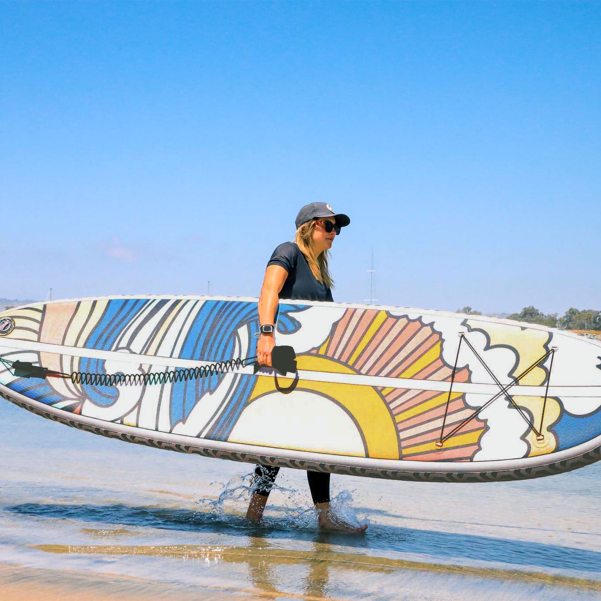 A woman carrying the stowaway art print paddleboard