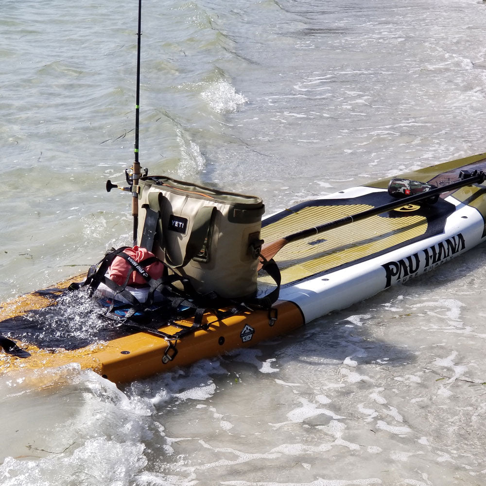 "Pau Hana Surf Supply Endurance SUP rigged for fishing in choppy conditions, showing rod holder and cooler setup"