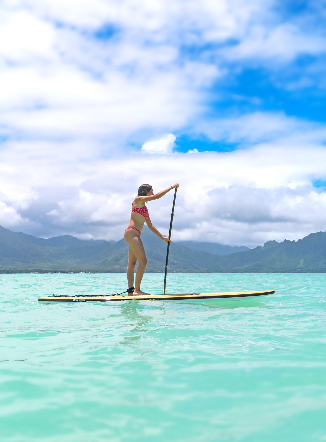 Pau Hana Surf Supply rider on 11'0" Big EZ Hawaiian VFT at Oahu's Kaneohe Sandbar, turquoise waters beneath Ko'olau peaks