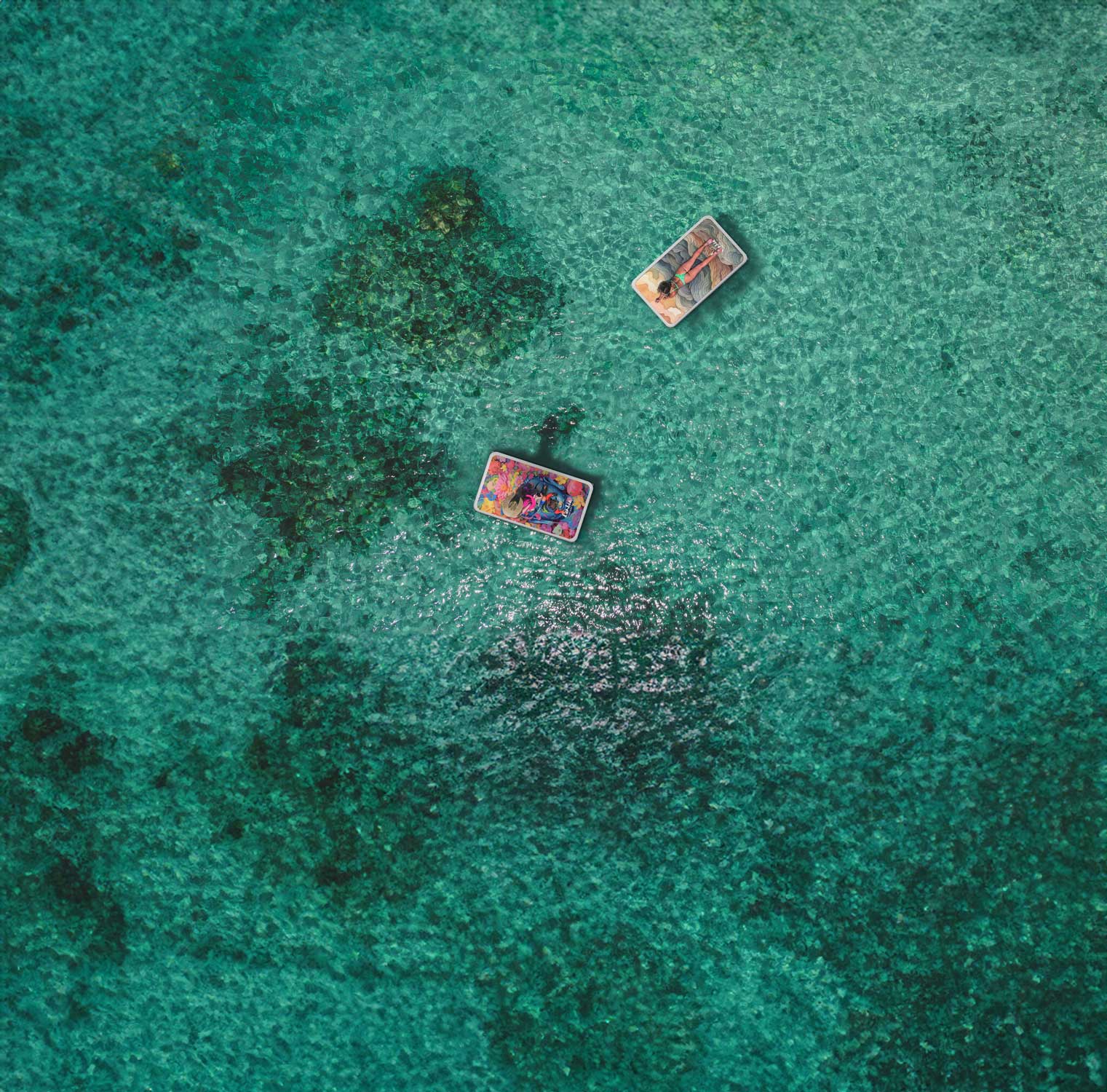 "Aerial view of two Pau Hana Cambia inflatable platforms floating on turquoise Hawaiian waters, versatile SUP-to-dock convertible design"