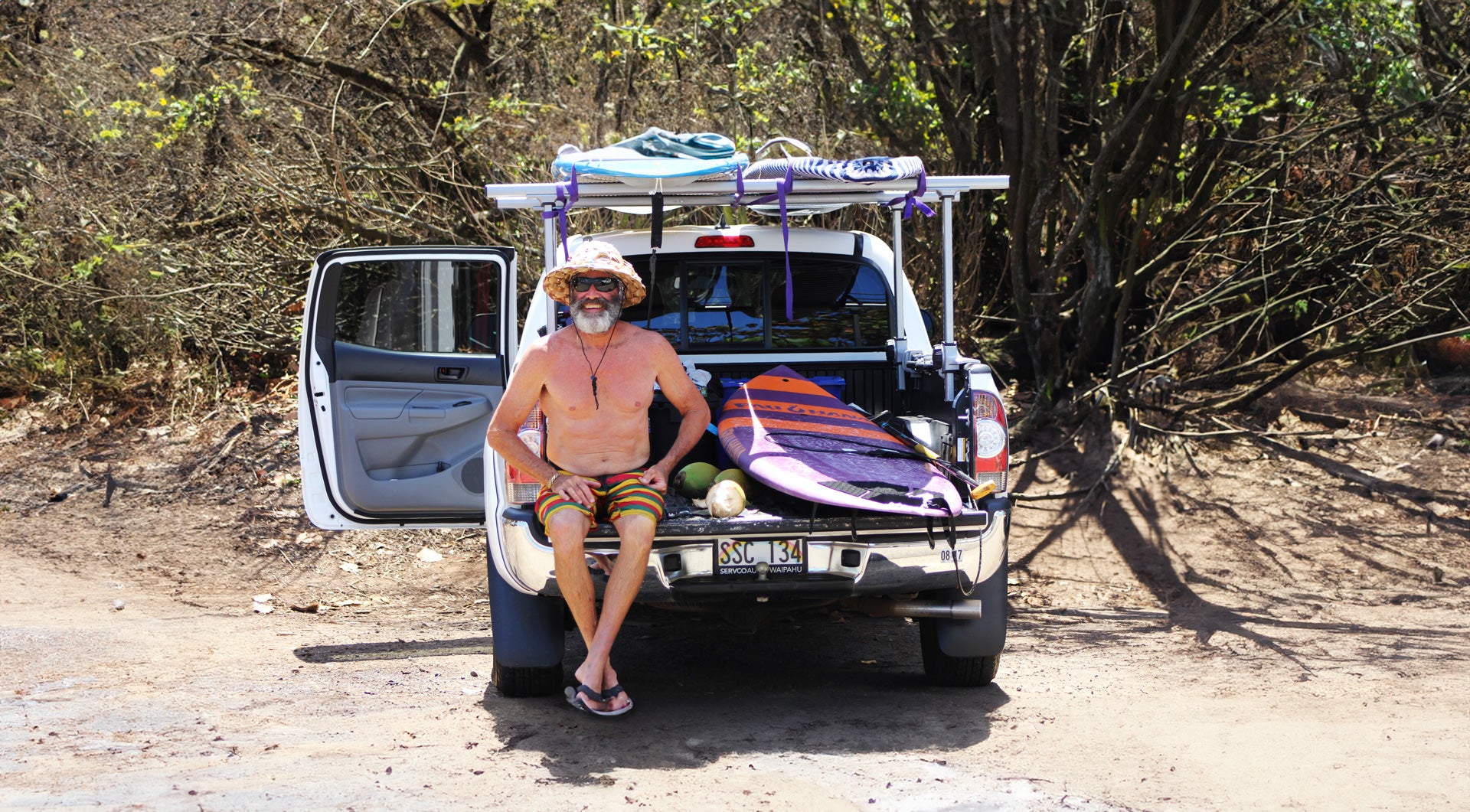 Pau Hana Surf Supply Carve SUP paddle board in back of a truck in Hawaii