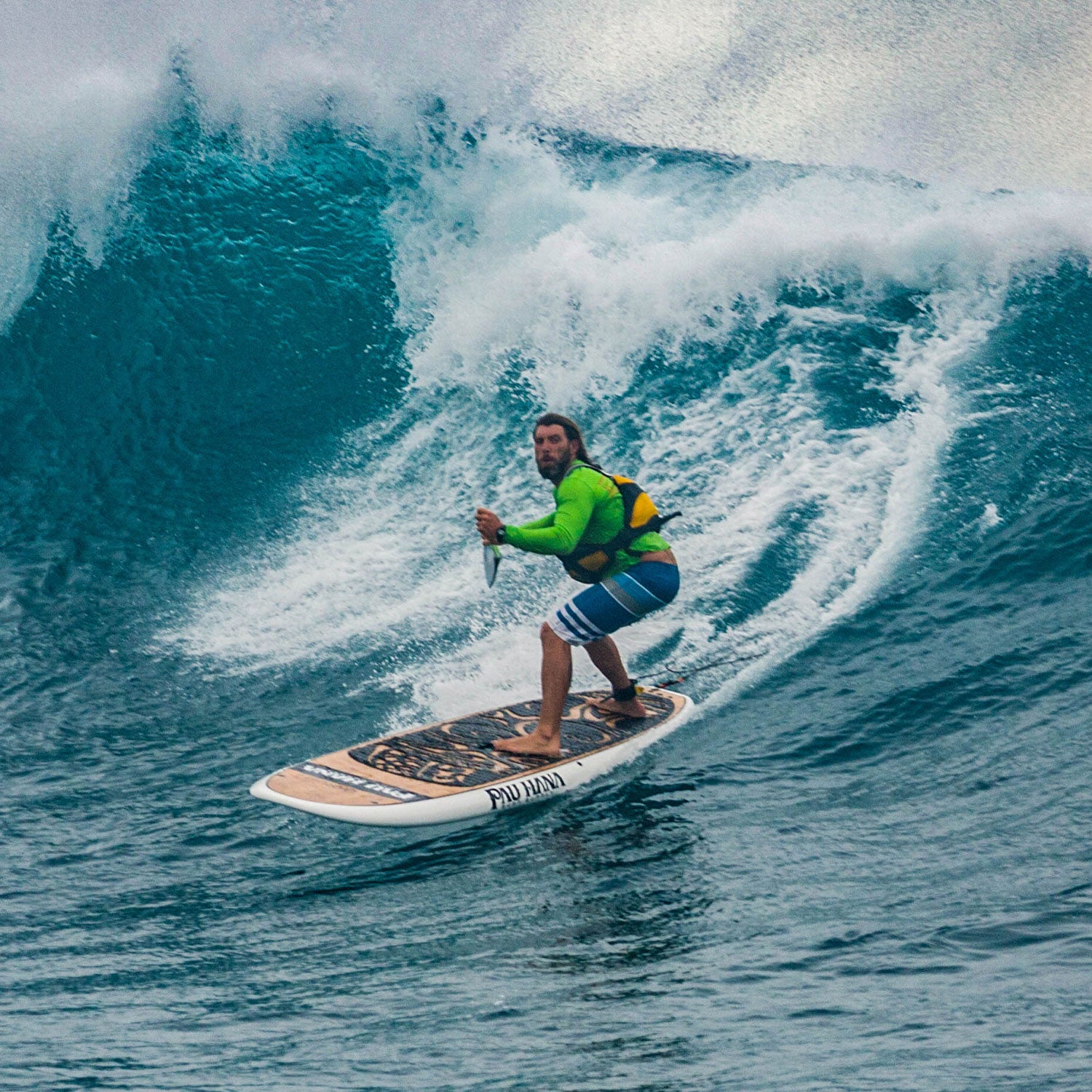 "Paddler riding massive wave on a Pau Hana Surf Supply nose rider the Oahu SUP at Oahu's North Shore"