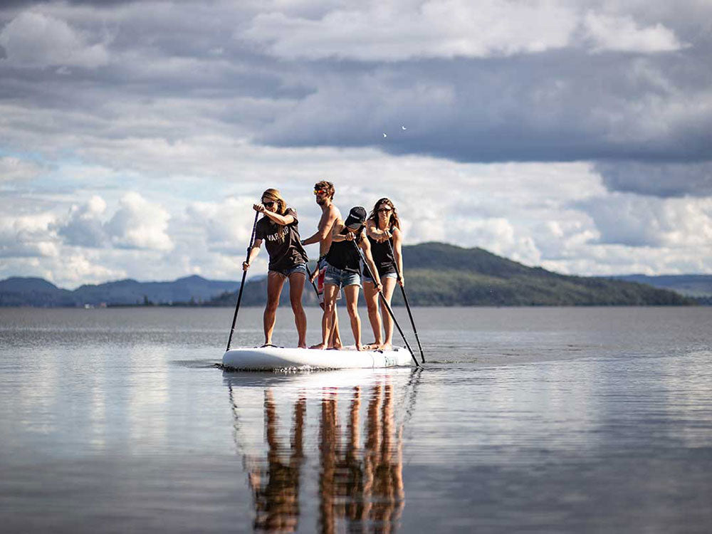 "Pau Hana Oahu Nui giant family inflatable SUP in serene New Zealand lake surrounded by mountains"